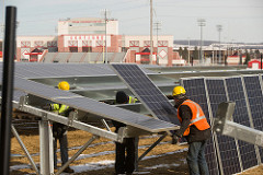 workers installing solar panels