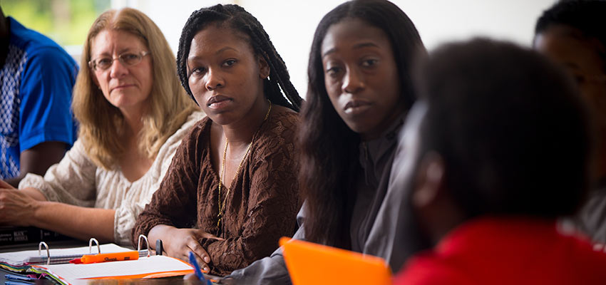 Students at a table engaged in conversation