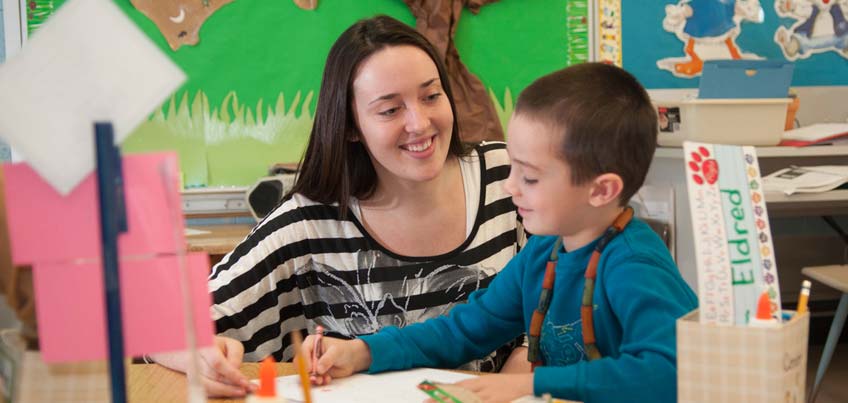 A teacher education candidate working with a young child in a classroom