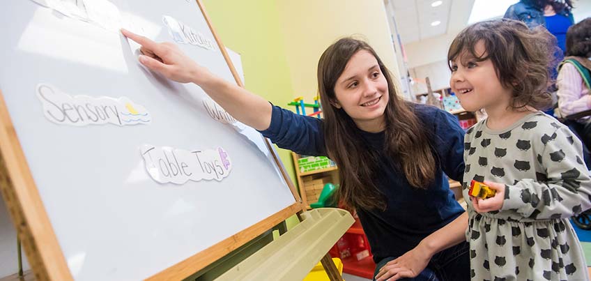 Student working with child in Child Care Center