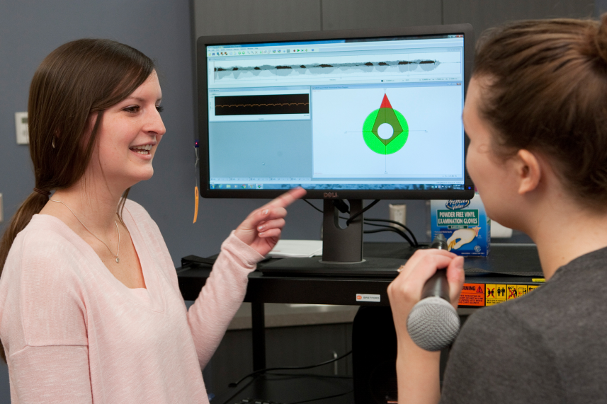 Student using computer equipment for the voice