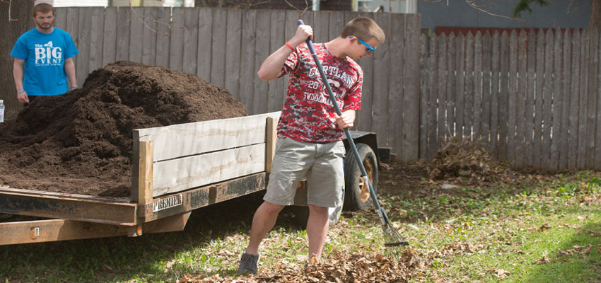 Student Raking Leaves