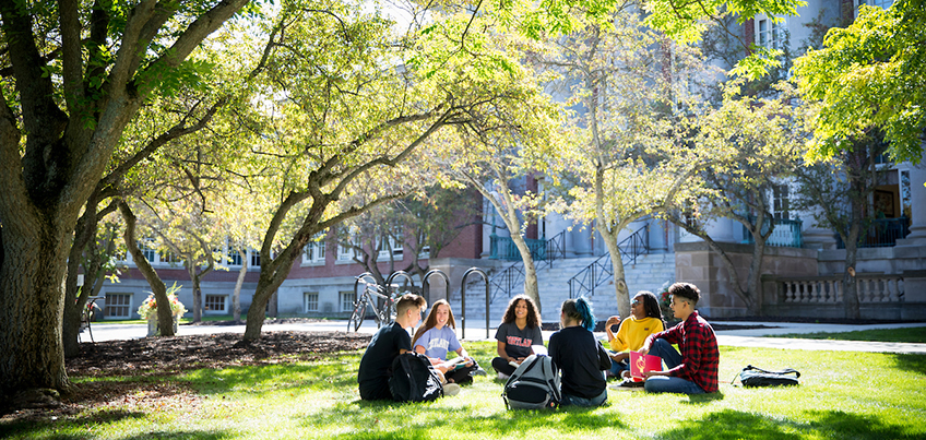 Students sitting and conversing outside Old Main