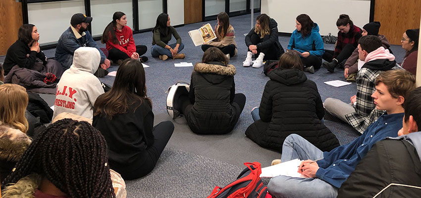 Teaching assistants model reading picture books to their peers and asking them philosophical questions