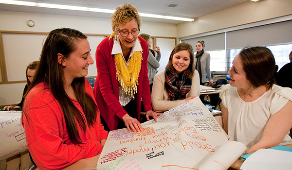 Literacy graduate students working with professor