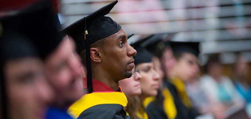 Graduate students standing in their row