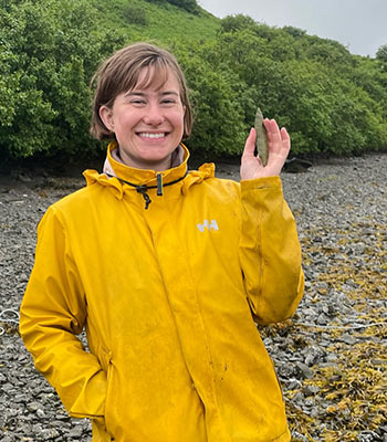 Katie with stone projectile point near the Old Harbor, AK archaeological site